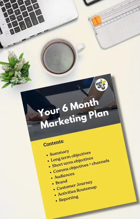Desk with marketing plan and laptop