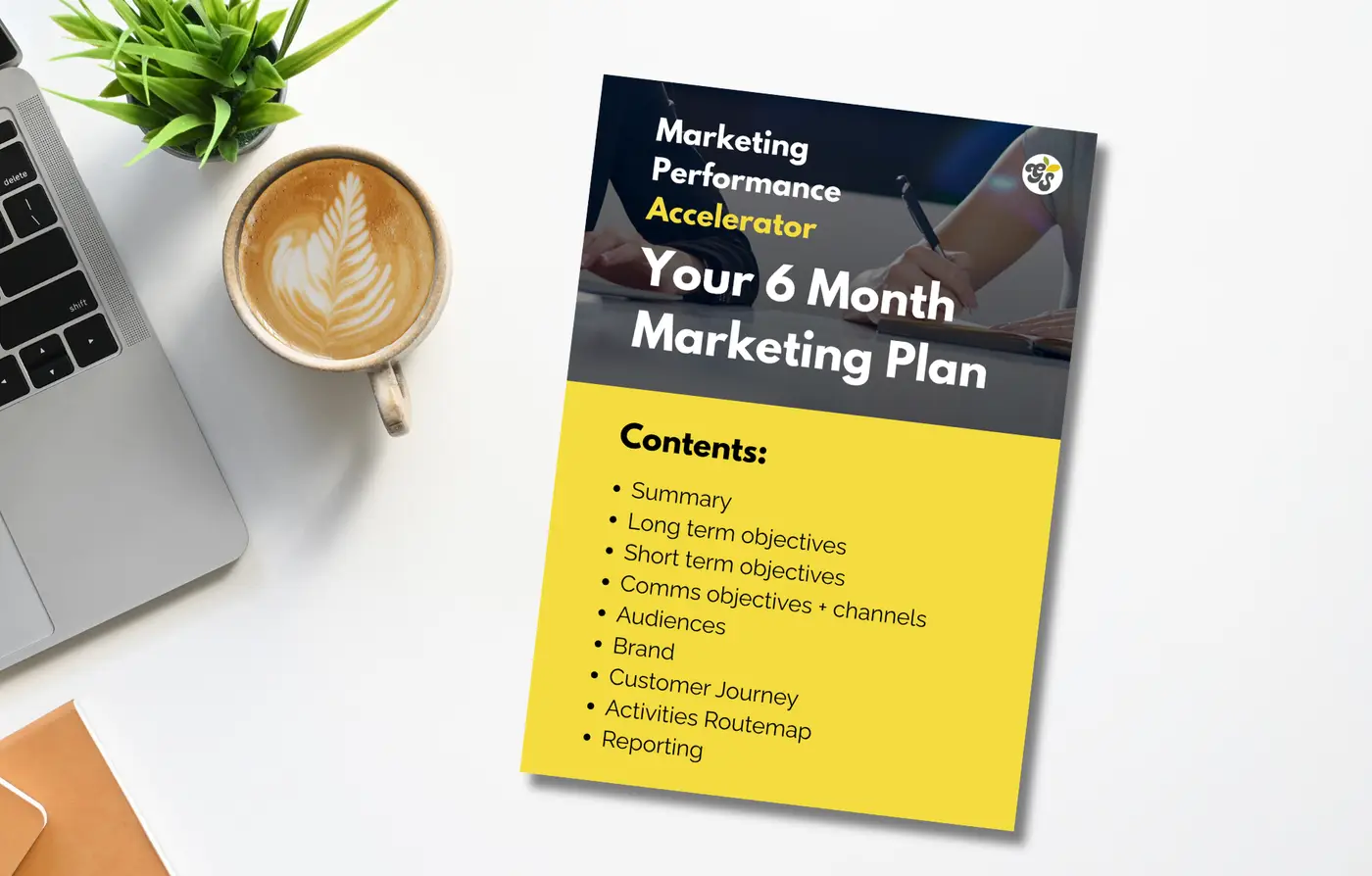Marketing plan on desk with laptop.