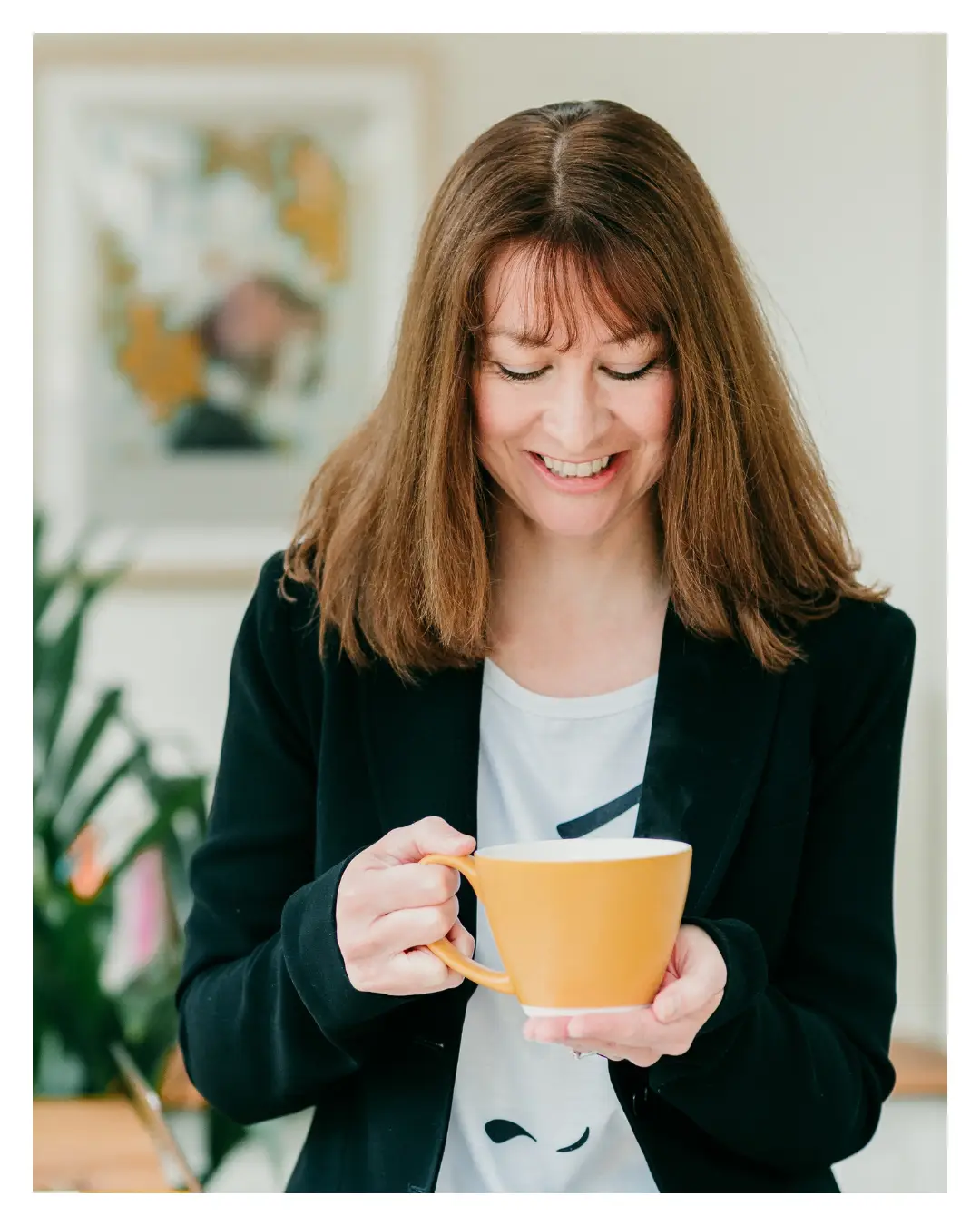 Image of a woman holding a coffee cup.